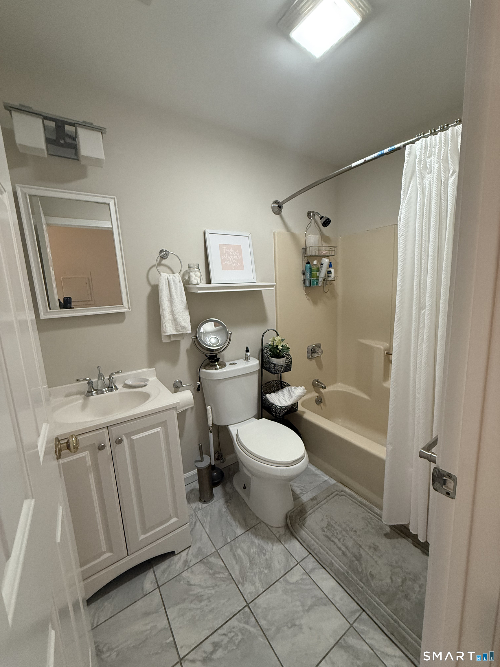 462 Glendale Avenue, Unit 20 Bridgeport, CT 06606 - Photo 11 of 13 a bathroom with a toilet sink and a mirror