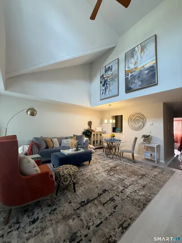 a living room with furniture and a clock