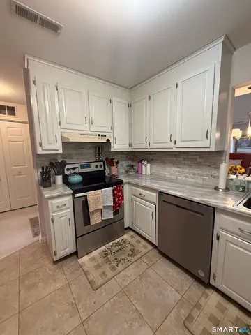 a kitchen with cabinets and appliances
