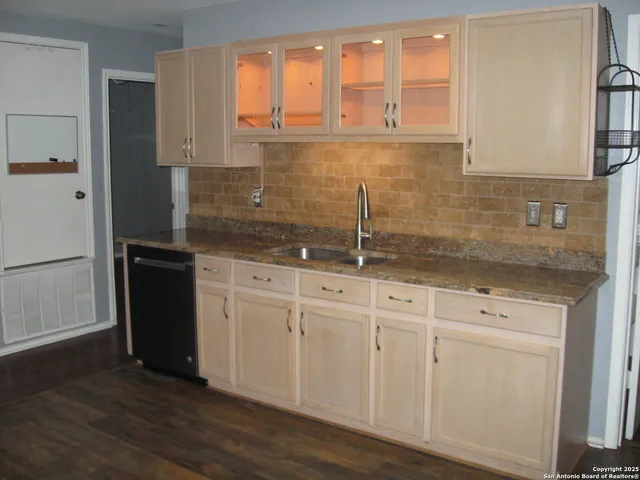 a kitchen with stainless steel appliances granite countertop a refrigerator and a sink