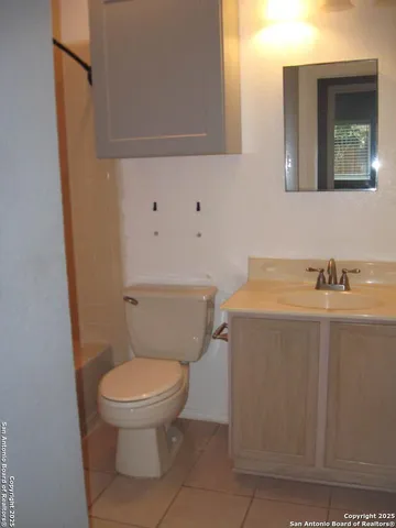 a white toilet sitting next to a bathroom sink