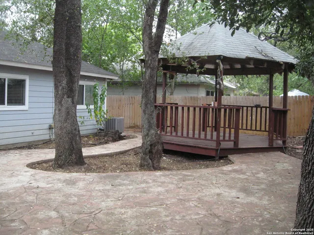 a view of a house with backyard and sitting area