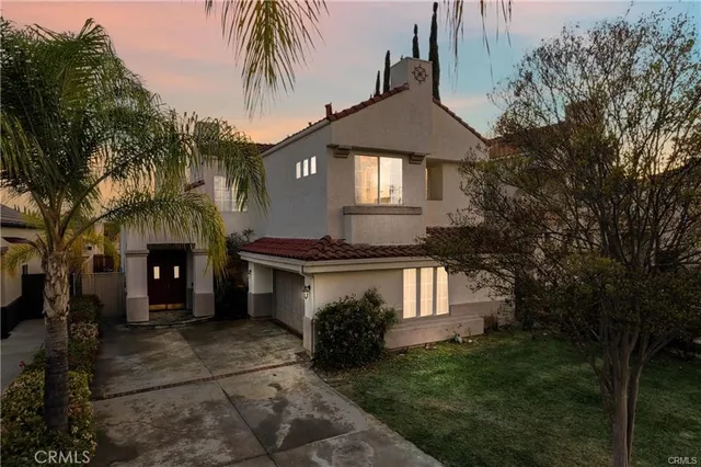 a front view of a house with a garden