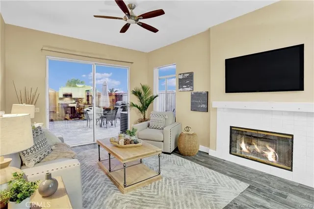 a living room with furniture a flat screen tv and a fireplace