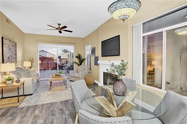 a living room with furniture a fireplace and a flat screen tv
