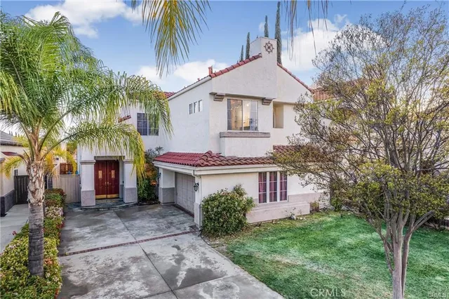 a front view of a house with a garden