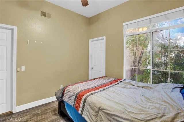 a bedroom with a bed and a large window