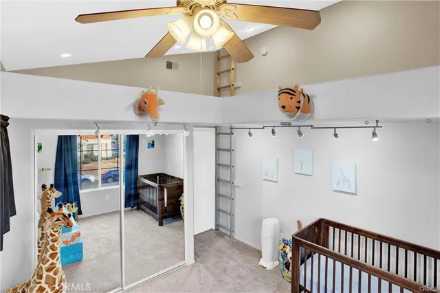 a view of a livingroom with furniture and a ceiling fan