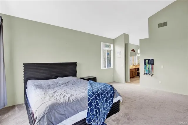 a bedroom with a bed and dresser