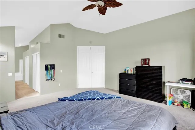 a bedroom with a bed and a dresser