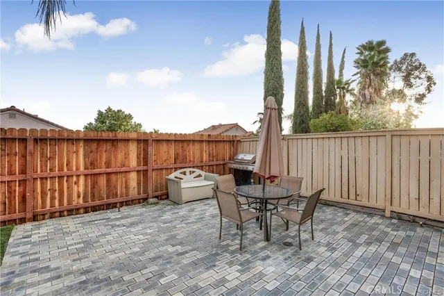 a backyard of a house with table and chairs