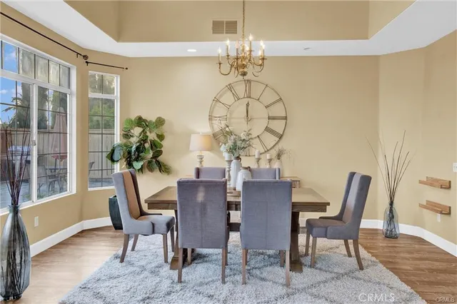 a view of a dining room with furniture wooden floor and chandelier