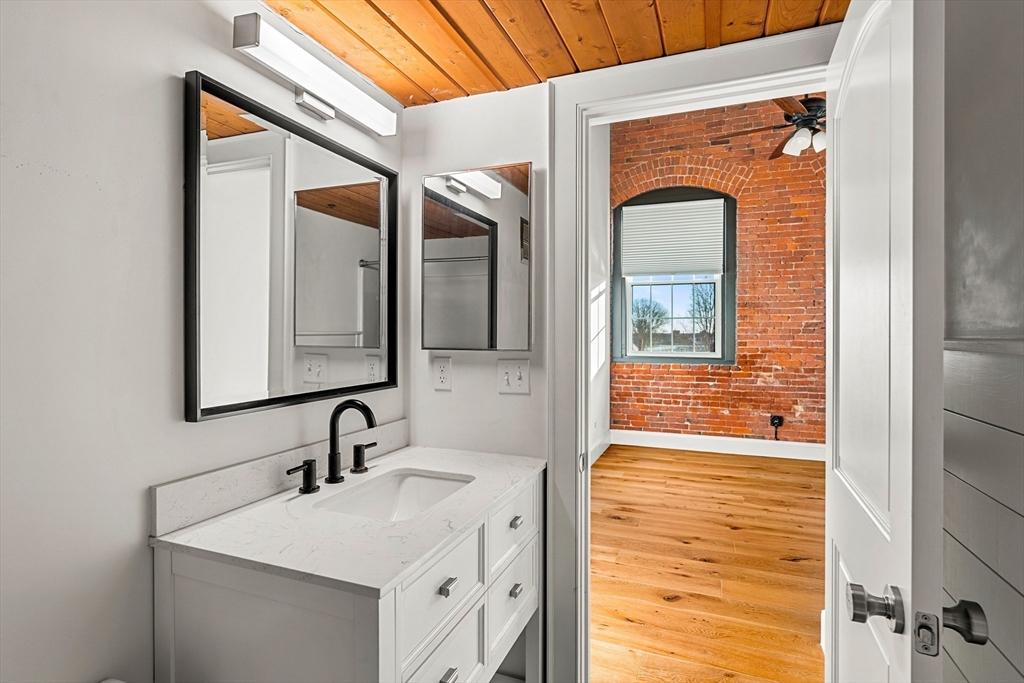 50 Rantoul Street, Unit 505 Beverly, MA 01915 - Photo 11 of 30 a bathroom with a sink and a mirror