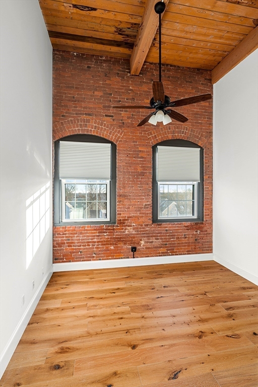 50 Rantoul Street, Unit 505 Beverly, MA 01915 - Photo 13 of 30 a view of an empty room with chandelier and wooden floor