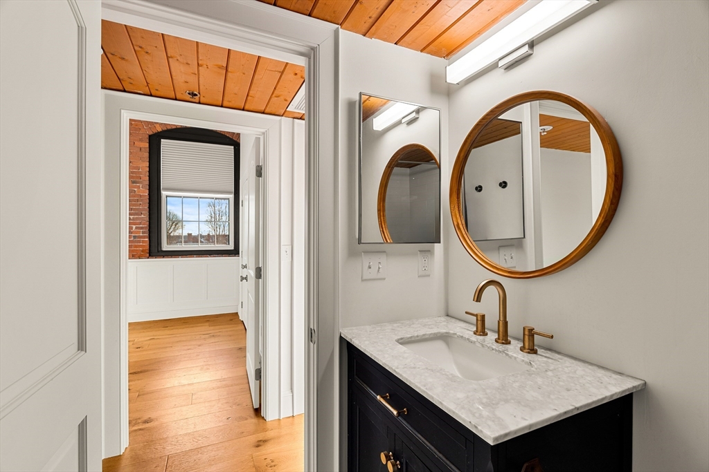 50 Rantoul Street, Unit 505 Beverly, MA 01915 - Photo 18 of 30 a bathroom with a sink and a mirror