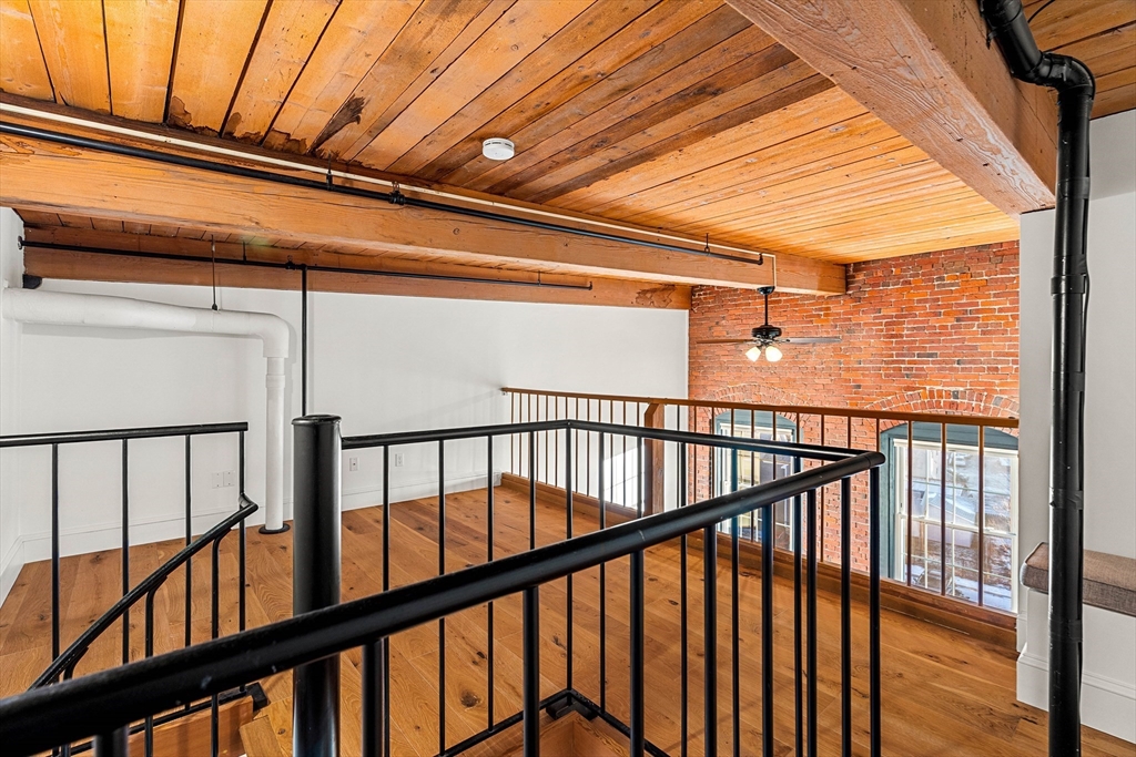 50 Rantoul Street, Unit 505 Beverly, MA 01915 - Photo 21 of 30 a view of staircase with railing and wooden floor