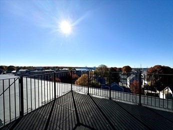 50 Rantoul Street, Unit 505 Beverly, MA 01915 - Photo 30 of 30 a view of a balcony with wooden floor