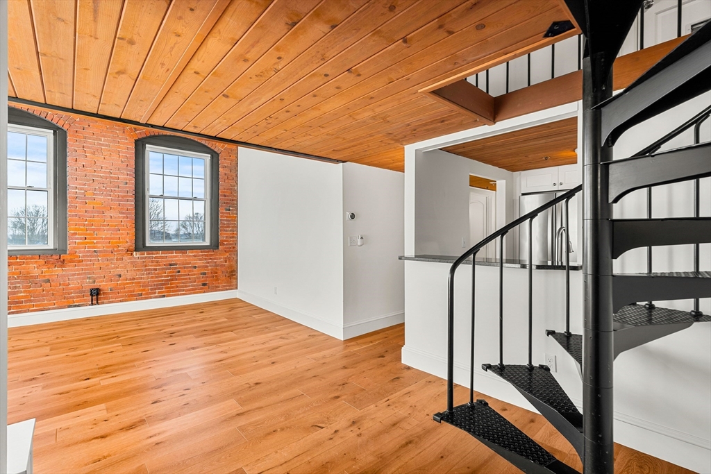 50 Rantoul Street, Unit 505 Beverly, MA 01915 - Photo 4 of 30 a view of an entryway with wooden floor and door