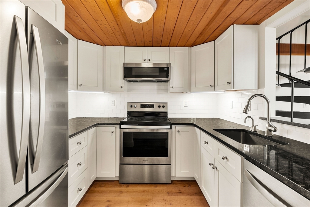 50 Rantoul Street, Unit 505 Beverly, MA 01915 - Photo 6 of 30 a kitchen with stainless steel appliances granite countertop a sink a stove a refrigerator and cabinets