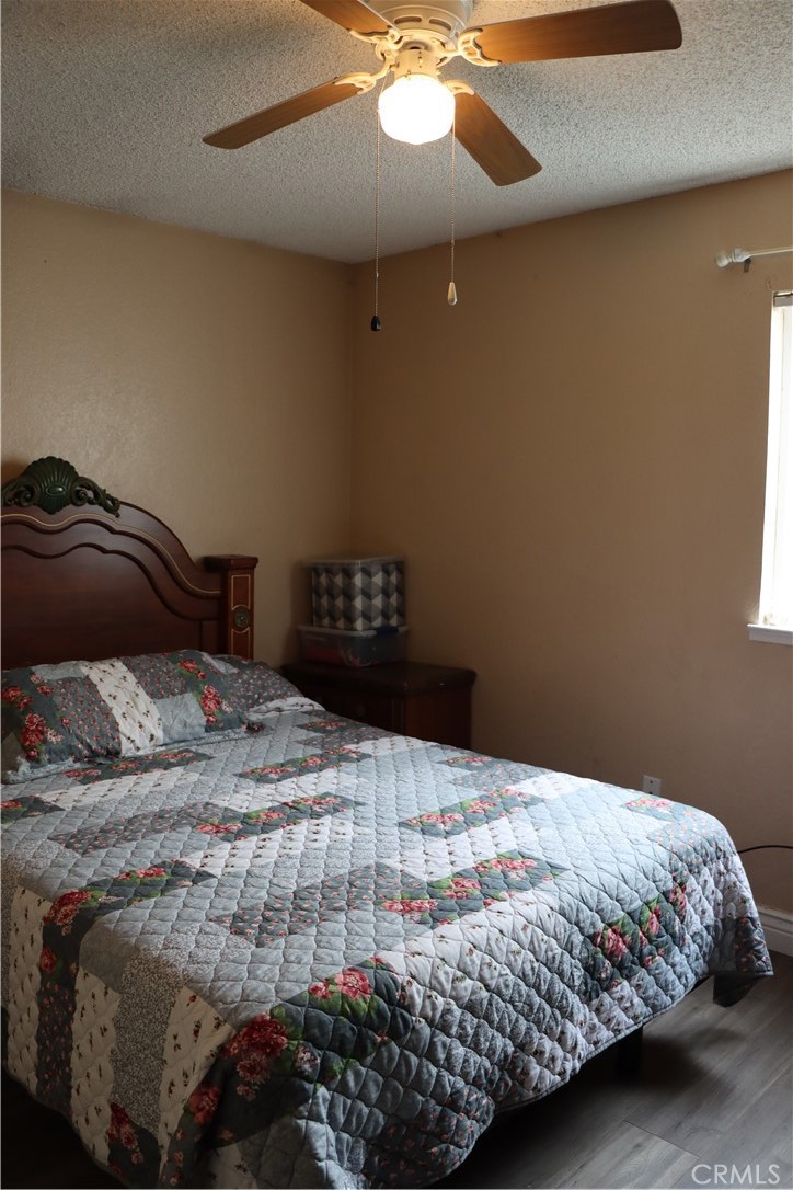 216 Barros Street Patterson, CA 95363 - Photo 19 of 38 a bedroom with a bed and a chandelier