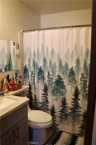 a bathroom with a toilet sink and window