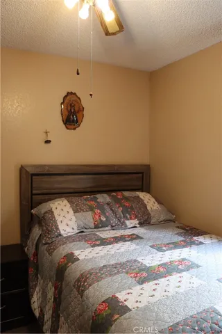 a bed sitting in a bedroom next to a lamp