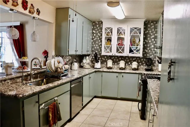 a kitchen with a sink window and cabinets