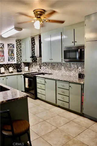 a kitchen with stainless steel appliances kitchen island granite countertop a sink and cabinets