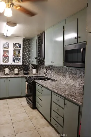 a kitchen with stainless steel appliances kitchen island granite countertop a sink and cabinets