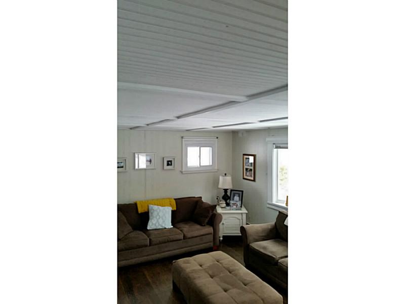 490 Middlebridge Road South Kingstown, RI 02879 - Photo 11 of 18 Living Room. Living Room in finished with a soft washed white hue, hardwood floors and new windows. The cottage is inviting and feels like you are living on the water or near the beaches which are only minutes away.