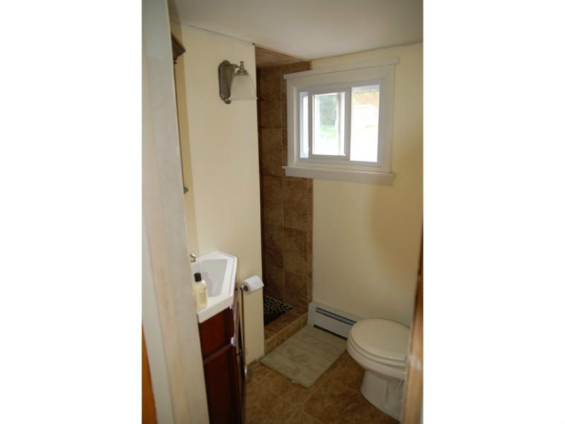 490 Middlebridge Road South Kingstown, RI 02879 - Photo 13 of 18 Bathroom. Bathroom is tastefully renovated with earthen tiled floor and shower.