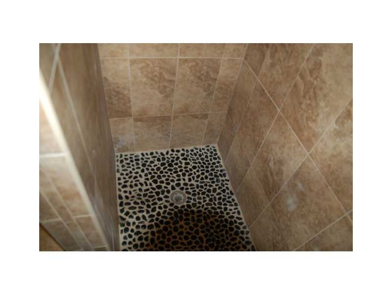 490 Middlebridge Road South Kingstown, RI 02879 - Photo 15 of 18 Bathroom. The modernize bathroom includes a fully tiled shower from floor to ceiling.