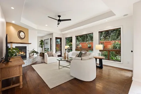 a living room with fireplace furniture and a large window