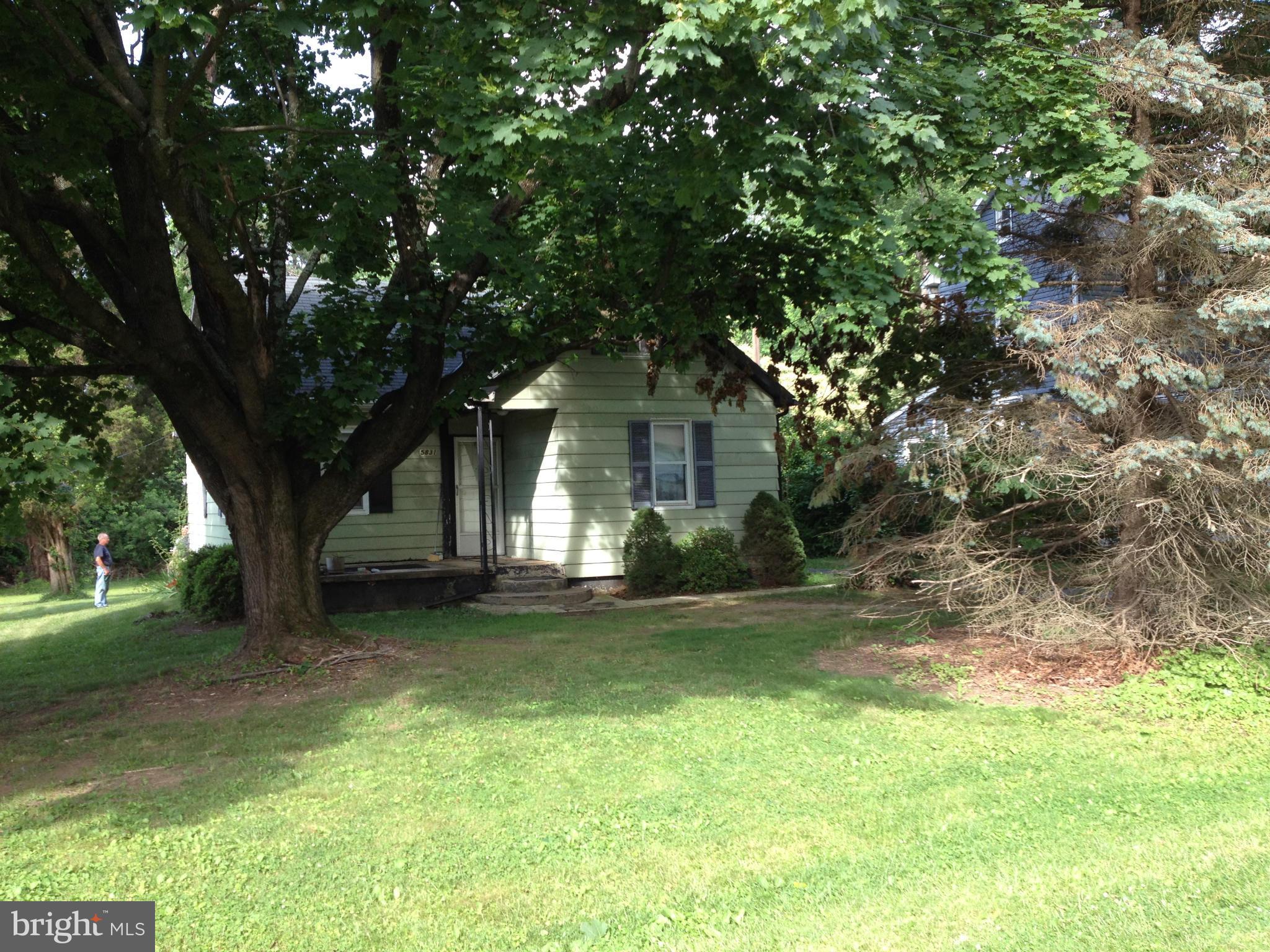 5831 Shookstown Road Frederick, MD 21702 - Photo 2 of 7 a front view of a house with a garden and trees