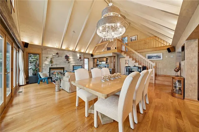 a view of a dining room with furniture wooden floor and chandelier