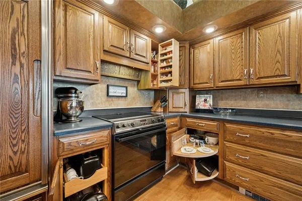 a kitchen with stainless steel appliances granite countertop a stove and a sink