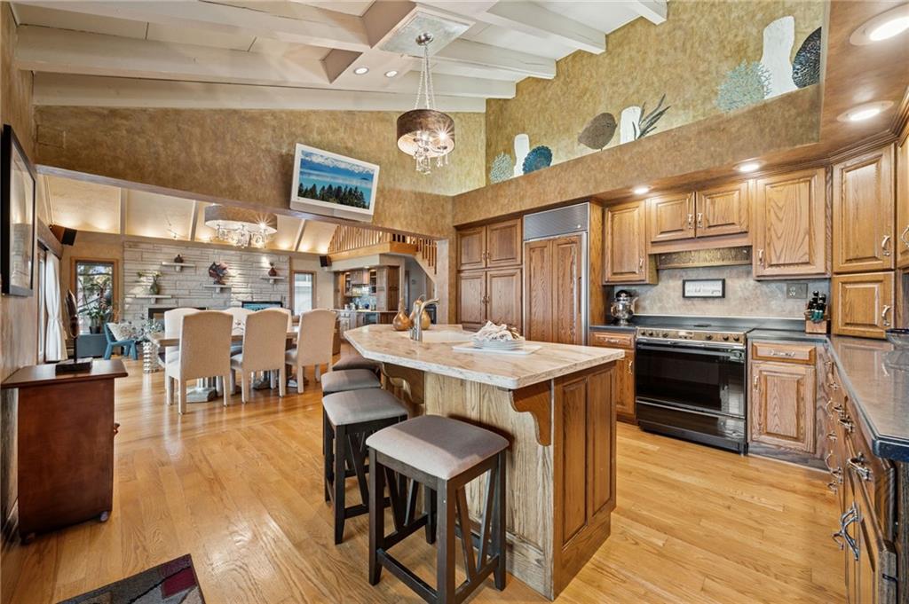 288 Latonka Drive Mercer, PA 16137 - Photo 21 of 42 a kitchen with a stove a refrigerator and a dining table with wooden floor