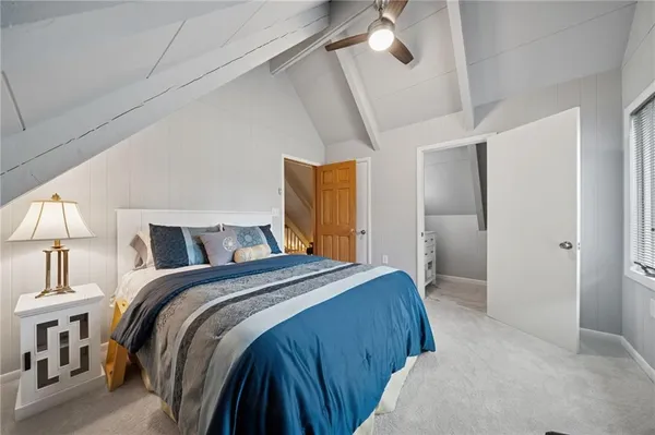 a bedroom with a bed and a mirror