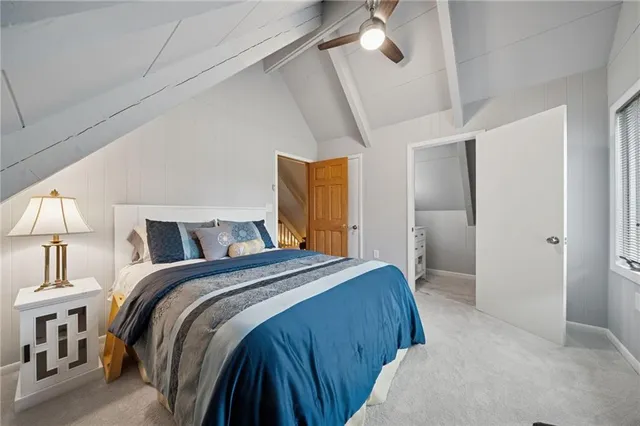 a bedroom with a bed and a mirror