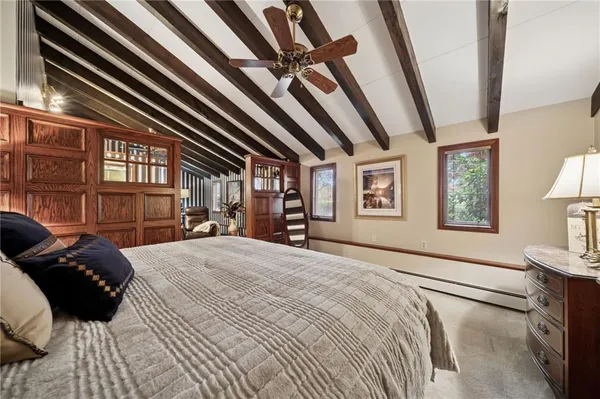 a bedroom with a bed next to a window