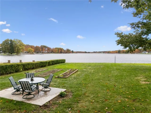 a view of a lake with couches in the patio