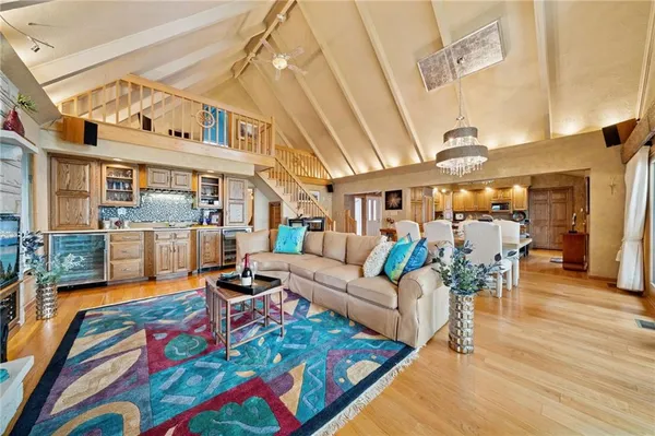 a living room with furniture a rug and a chandelier