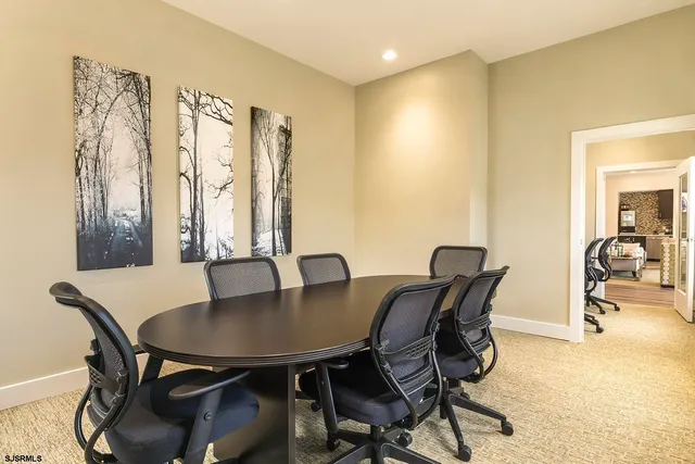 a view of a workspace with furniture and a computer on a desk