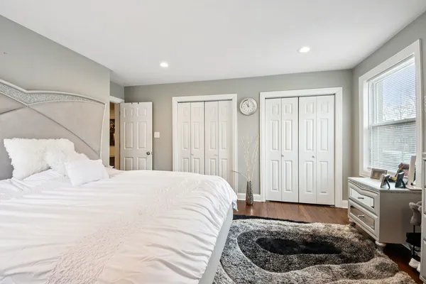 a bedroom with a large bed and a window