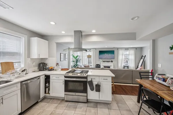 a kitchen with a stove sink and cabinets