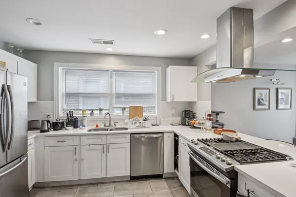 a kitchen with a sink stove and refrigerator