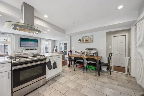a view of kitchen with sink stove and cabinets
