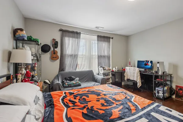 a bedroom with furniture and a large window