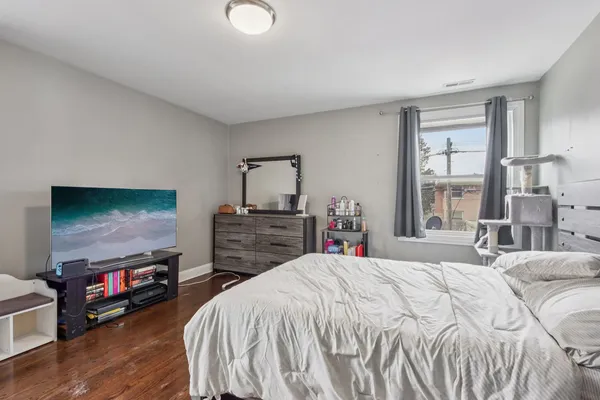 a bedroom with a bed and a television