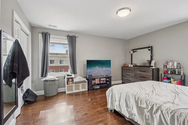 a bed room with furniture and a flat screen tv